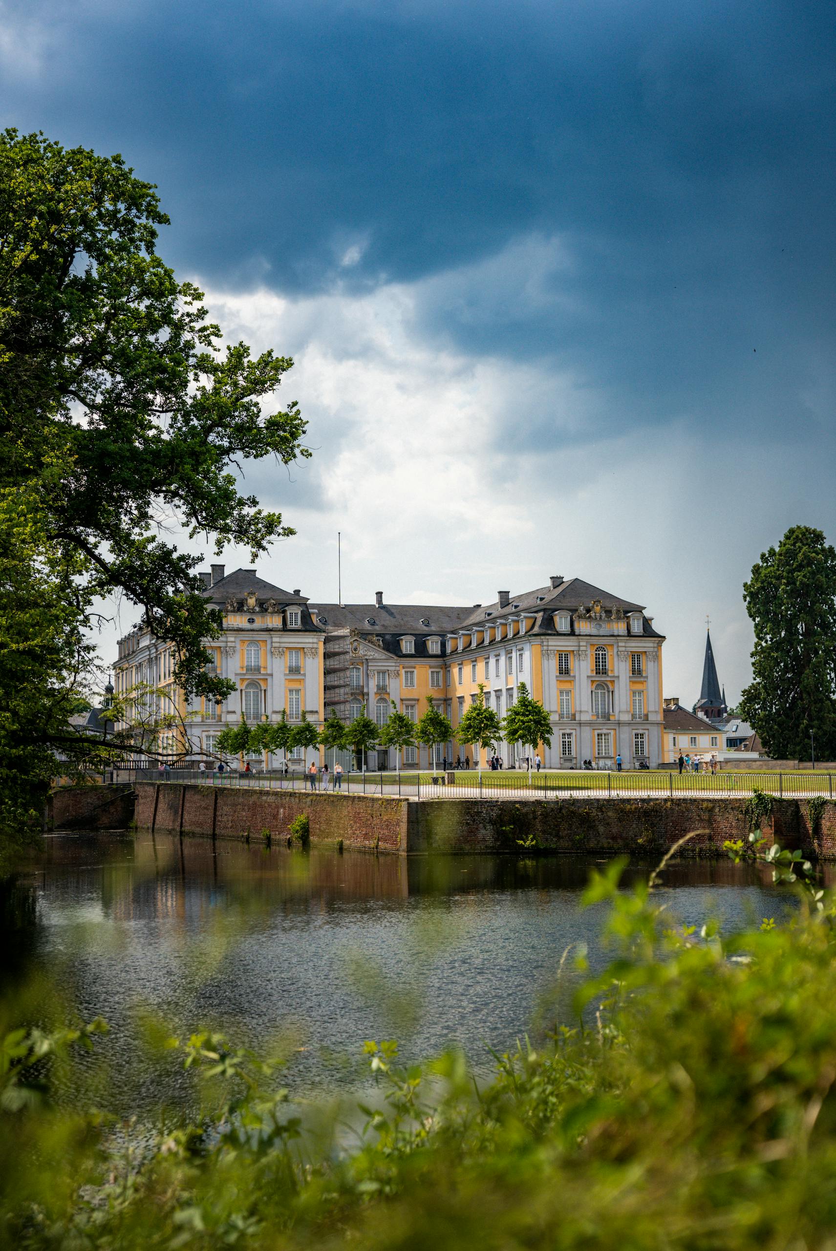 Majestic view of Augustusburg Palace in Brühl, NRW, Germany, with dramatic sky.